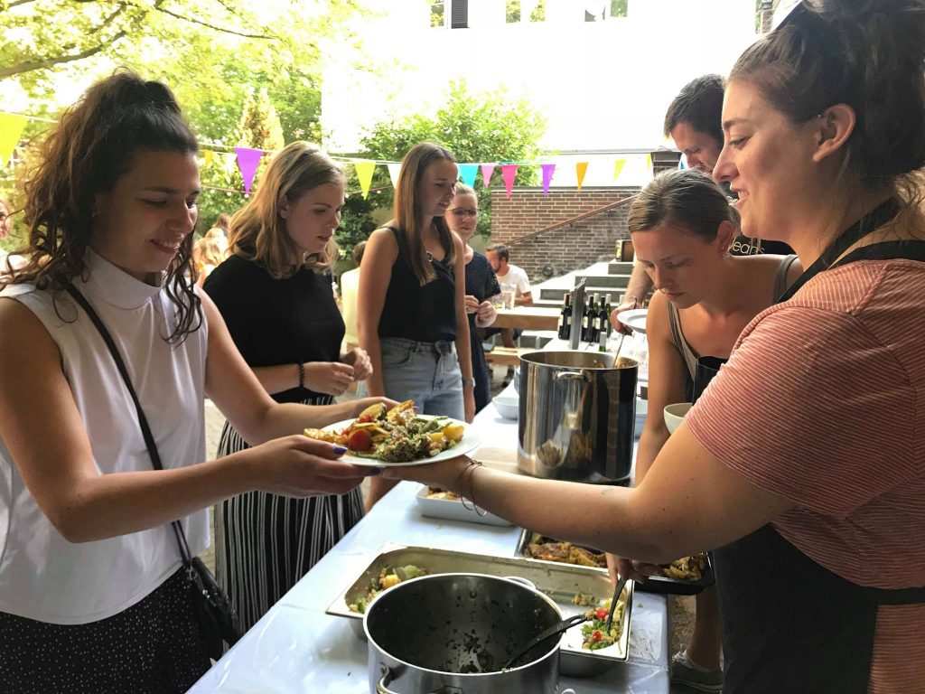 Photo of people serving food.